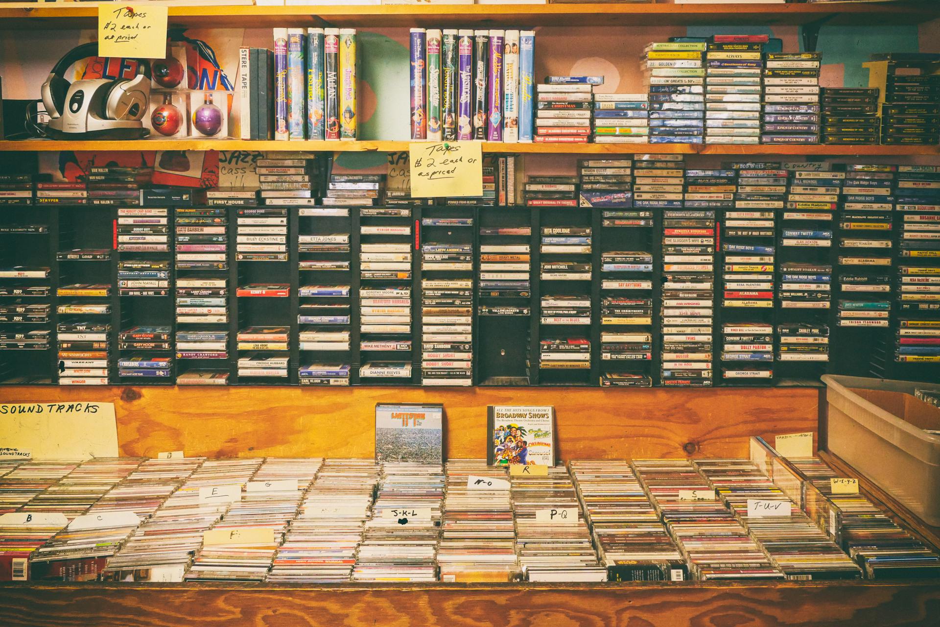 A nostalgic display of cassette tapes and CDs in a vintage record store.