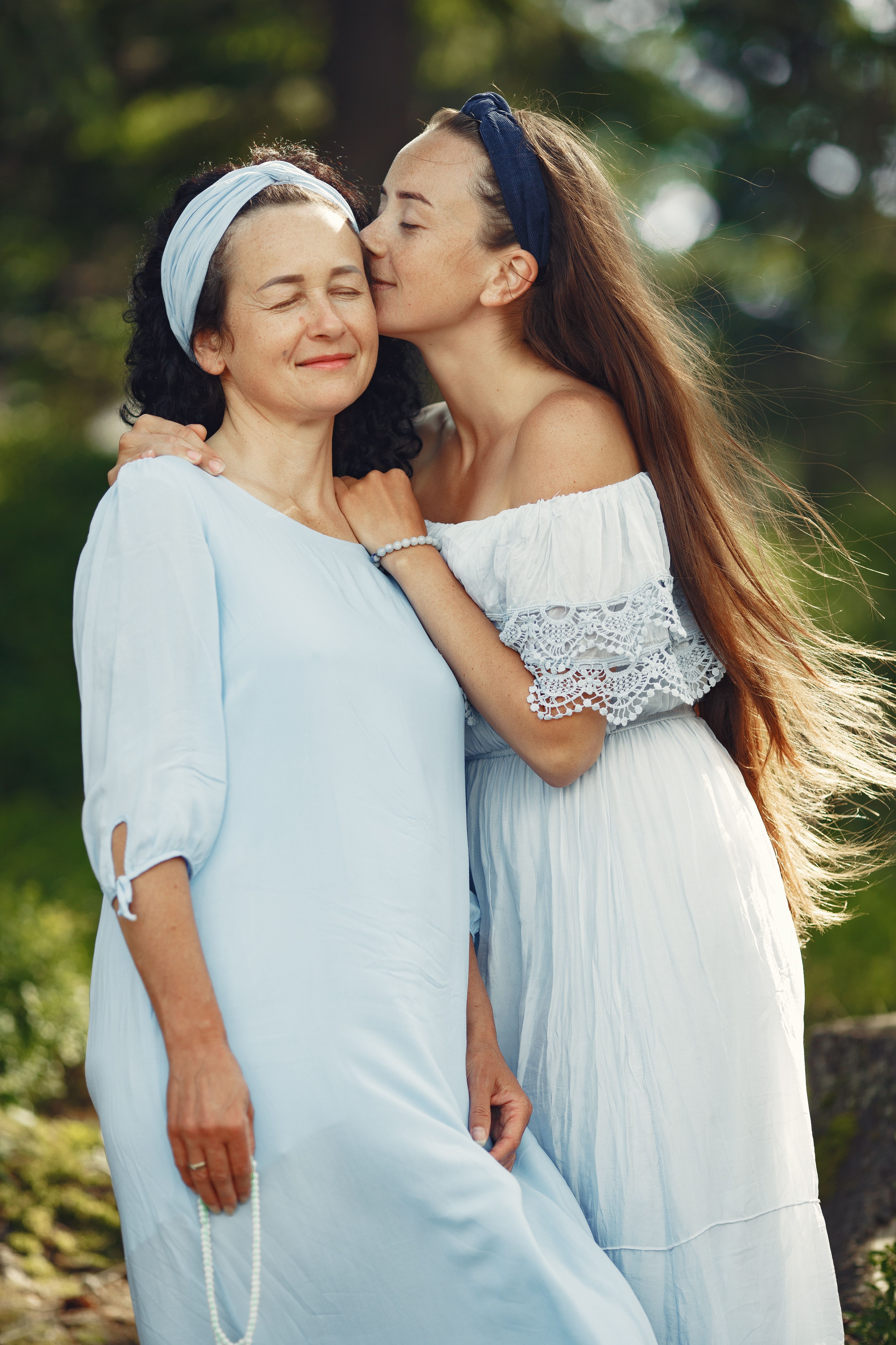woman-in-white-dress-kissing-woman-in-blue-dress-free-stock-photo