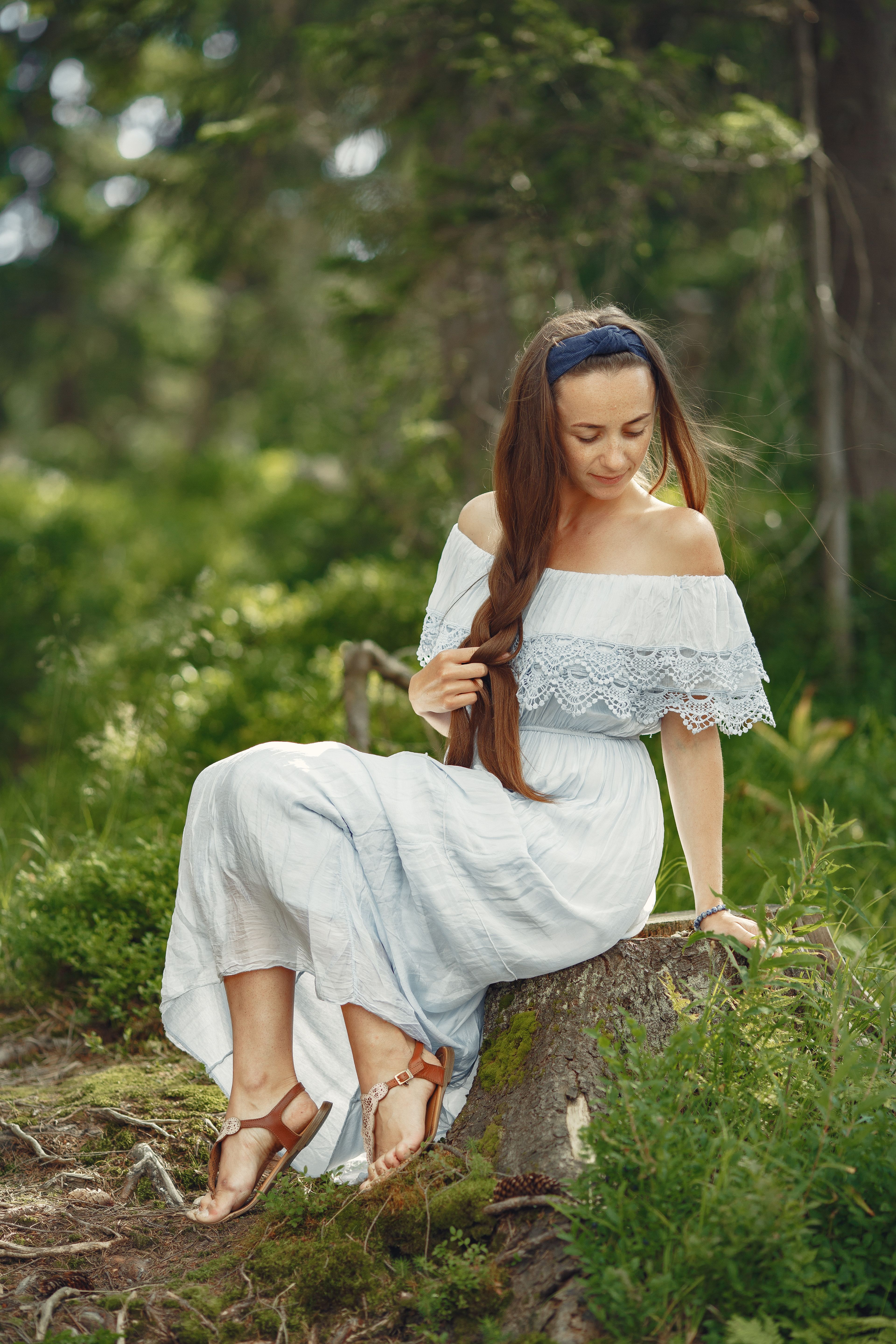 Woman in White Dress Sitting on Tree Stump · Free Stock Photo