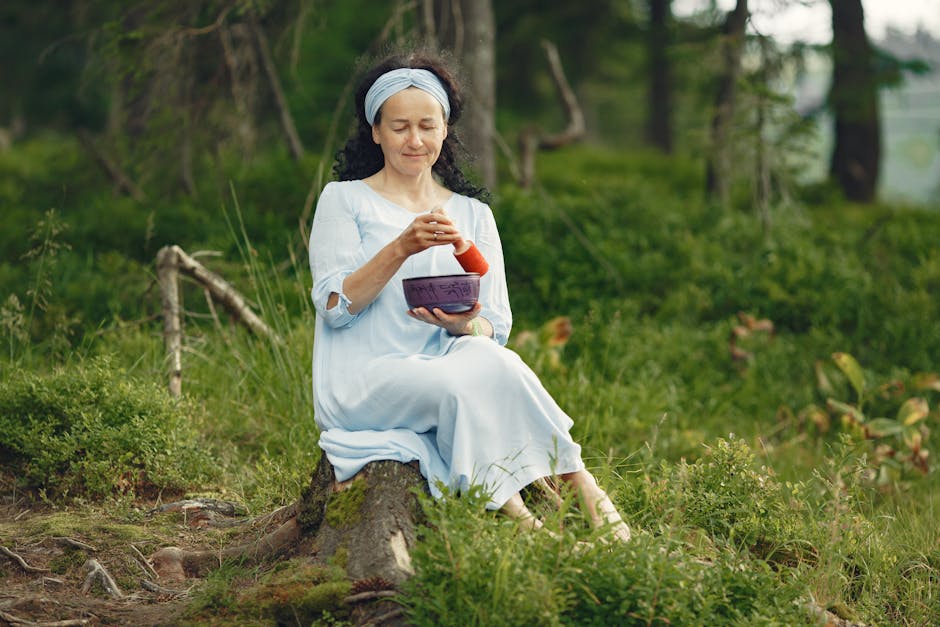 A woman practicing mindfulness with a singing bowl in a serene forest setting, embracing relaxation with burnout esgotamento profissional cristã