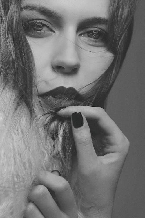 Free Grayscale Photo of Woman Holding Her Lips Stock Photo