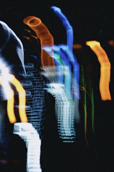 Abstract image of vivid neon light trails forming mysterious patterns on a black background.