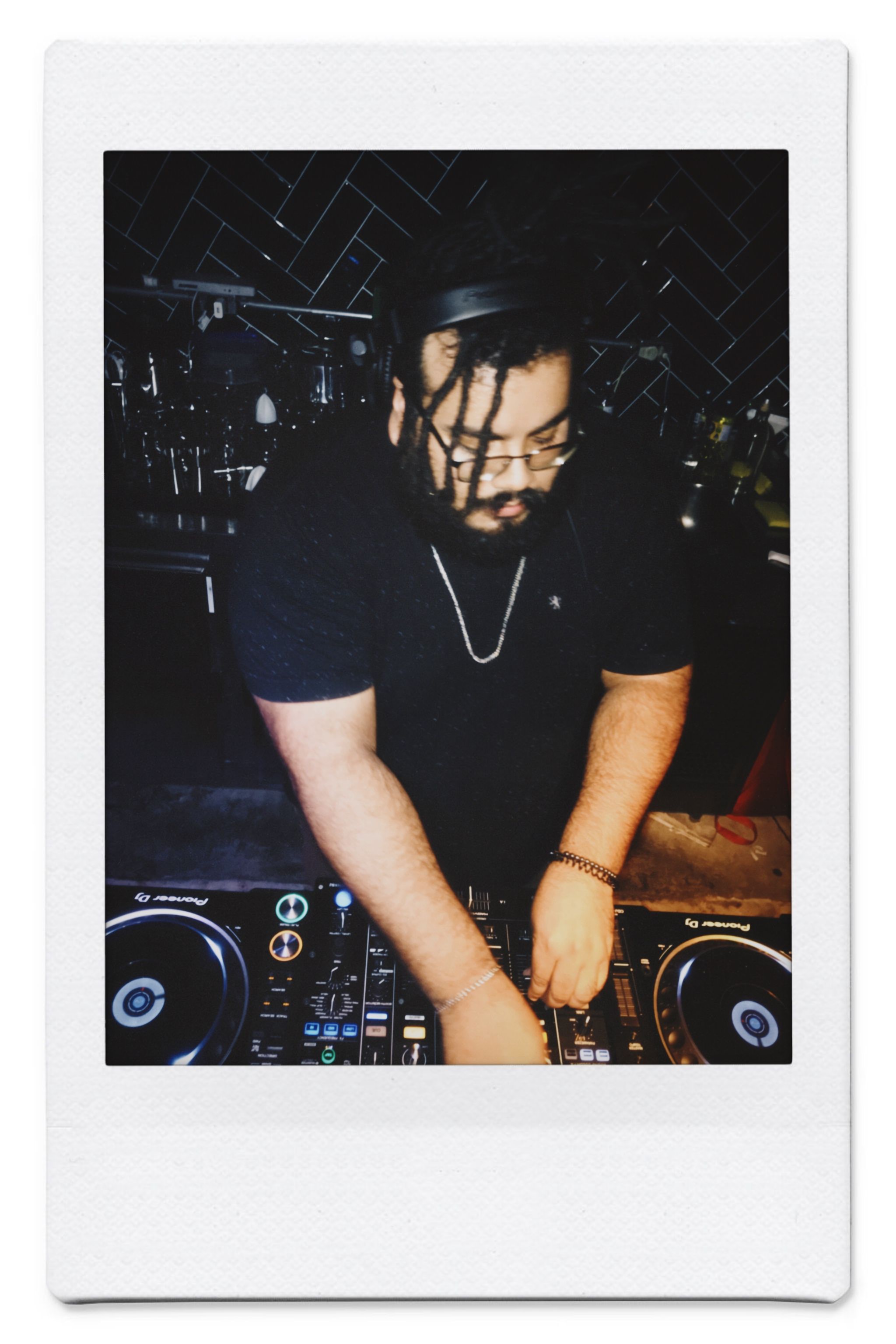 A DJ mixes music at a lively nightclub event, creating an energetic atmosphere.