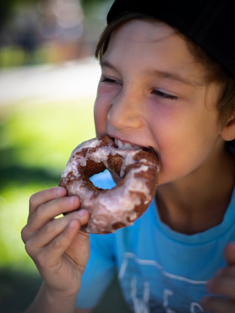 Boy In Blue Crew Neck Shirt Eating Doughnut