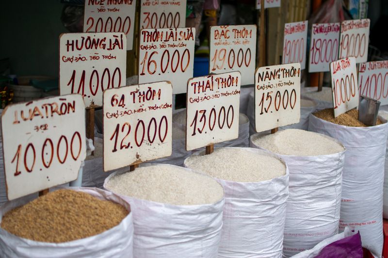 A display of various rice types for sale at a Ho Chi Minh City market stall.