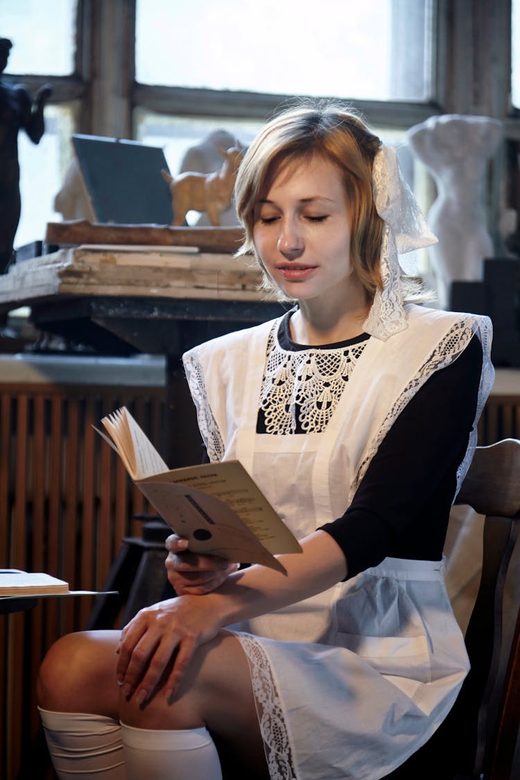 Focused Woman In Soviet School Uniform With Book