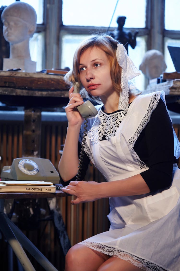 Woman In Soviet School Uniform Talking On Retro Telephone