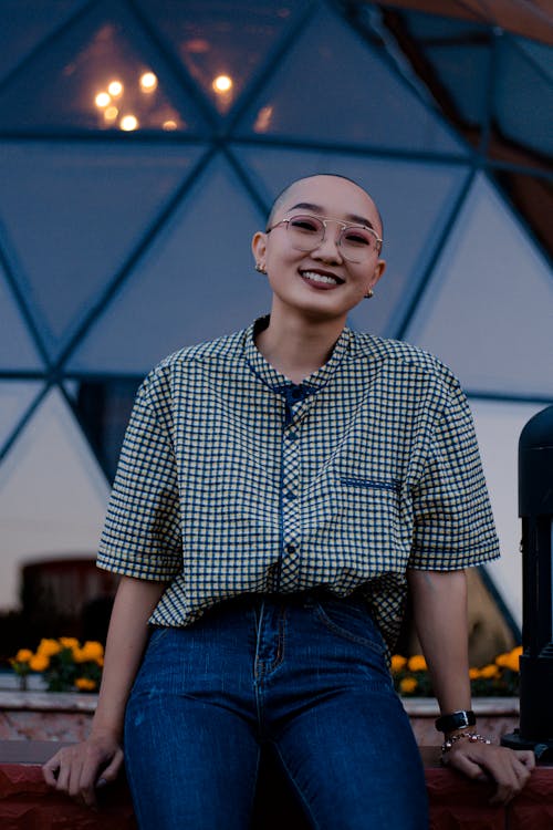 Cheerful person leaning to curb with friendly smile