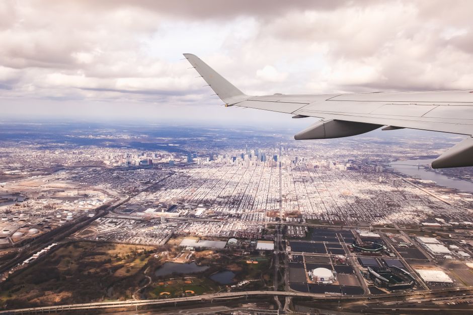 Outstanding Family Pack 48 Miles Helicopter Tour over Theme Parks & Downtown Review 2026 - Airplane wing overlooking a sprawling cityscape with cloudy skies.