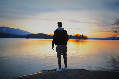 Free Man Standing on Front Body of Water Stock Photo