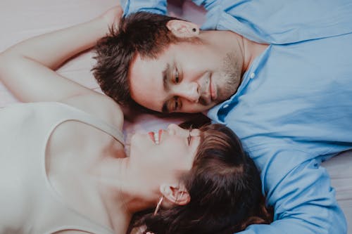 Free Happy Asian couple lying on bed Stock Photo
