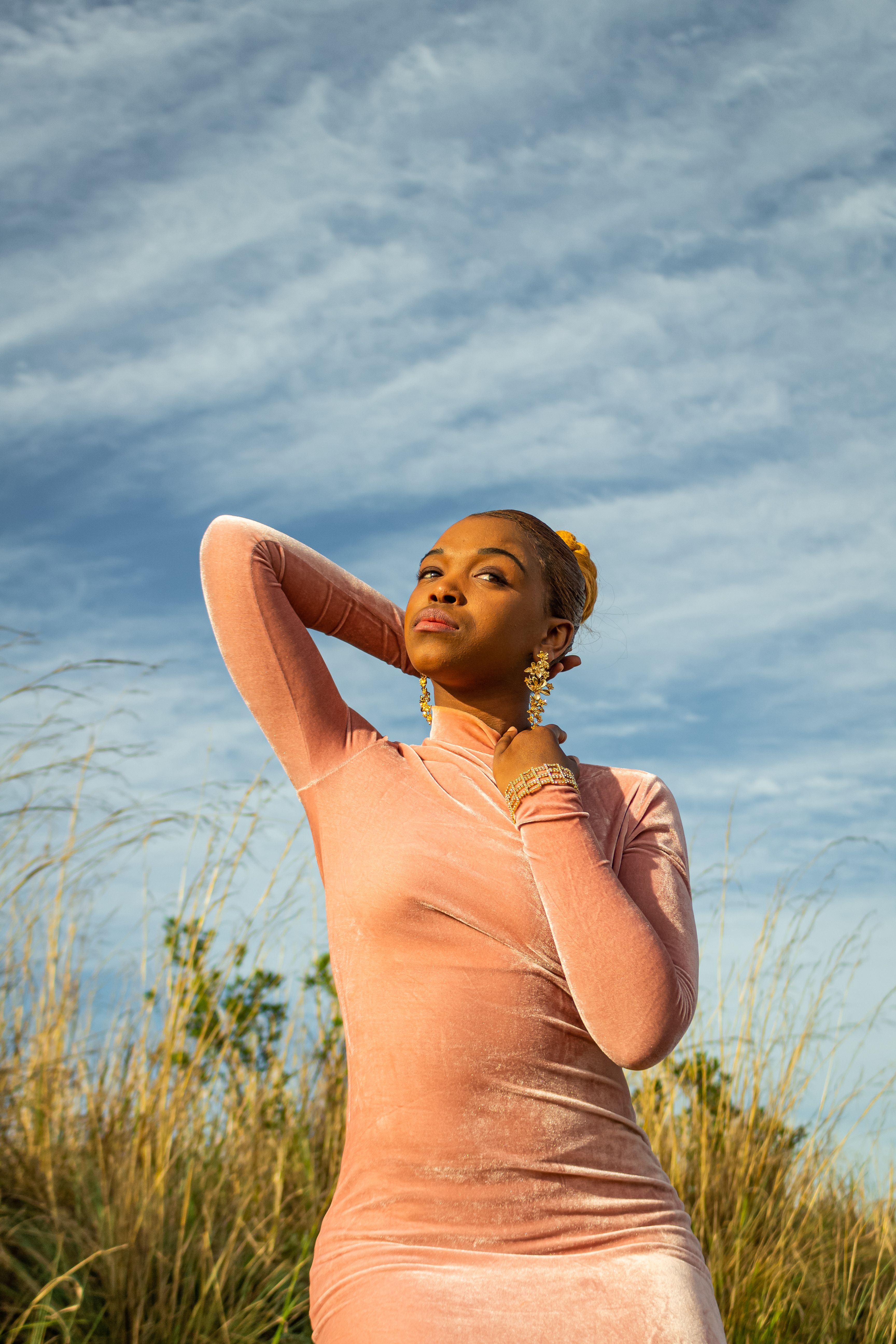 Woman in Pink Dress Standing on Green Grass Field · Free Stock Photo