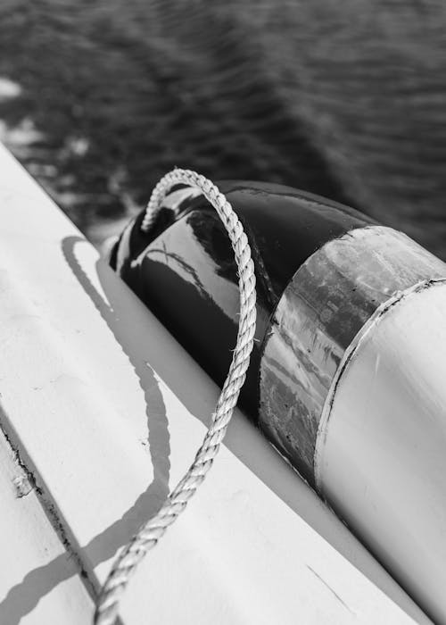 Free From above of black and white of ship deck with rope for anchor over sea water Stock Photo