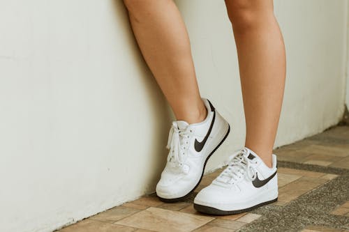 Person Wearing White Nike Sneakers