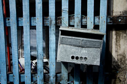 Mail Box Hanging on Wooden Fence