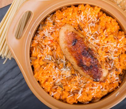 Savor this creamy pasta dish topped with grilled chicken and cheese for a flavorful meal.