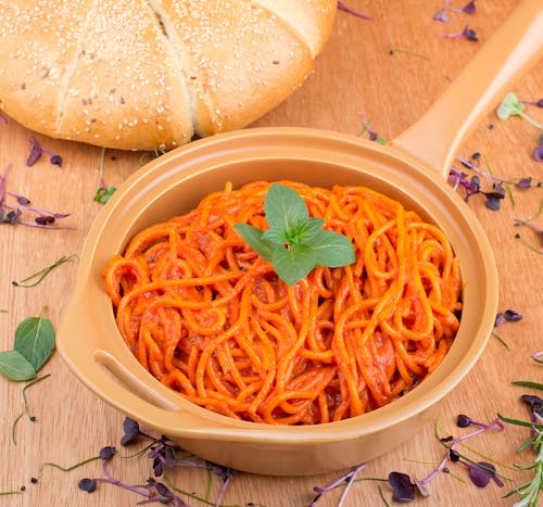 Free Spaghetti on Ceramic Pot Beside Bread Stock Photo