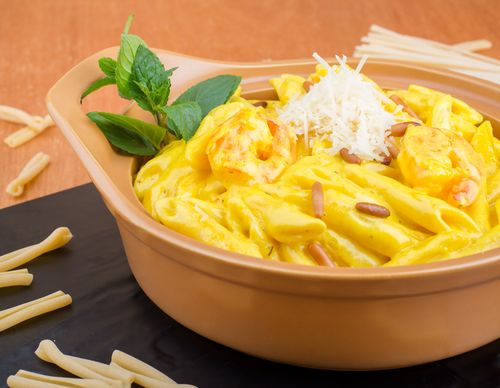 Free Indulge in creamy penne pasta topped with Parmesan and fresh basil, perfect for lunch or dinner. Stock Photo