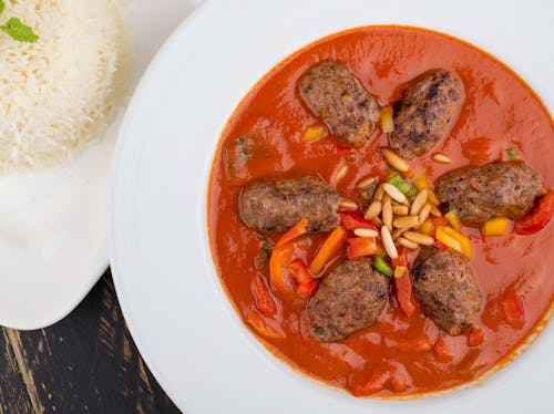 Cooked Meat with Red Sauce on White Ceramic Plate