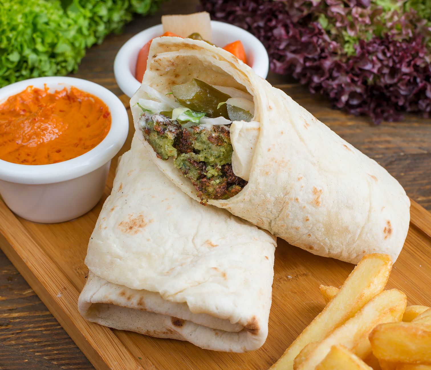 Fresh falafel wrap with vegetables on street food counter