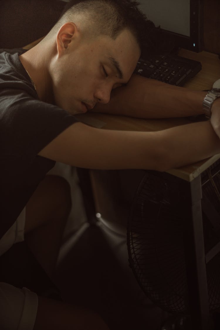 Sleepy Man Lying On Table