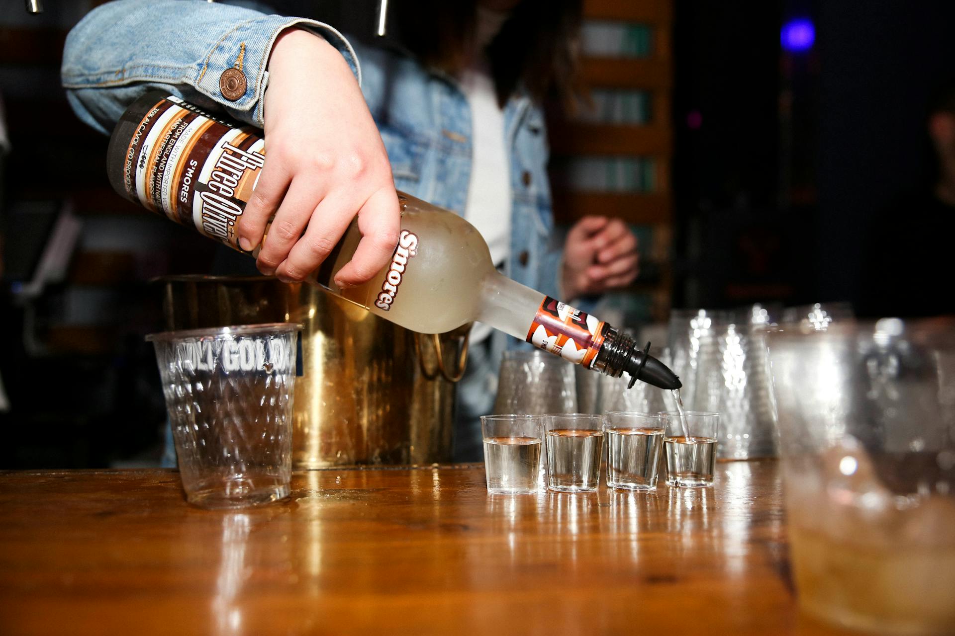 Person Pouring Alcoholic Drink in a Shot Glass