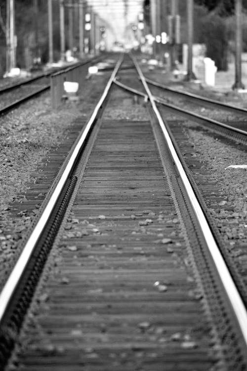 Grayscale Photo of Train Rail