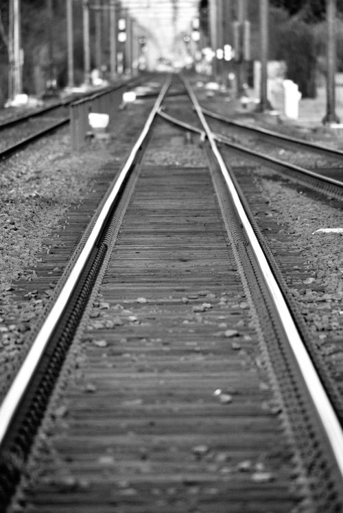 Free Black and white photo of railway tracks in Groenekan, depicting perspective and depth. Stock Photo