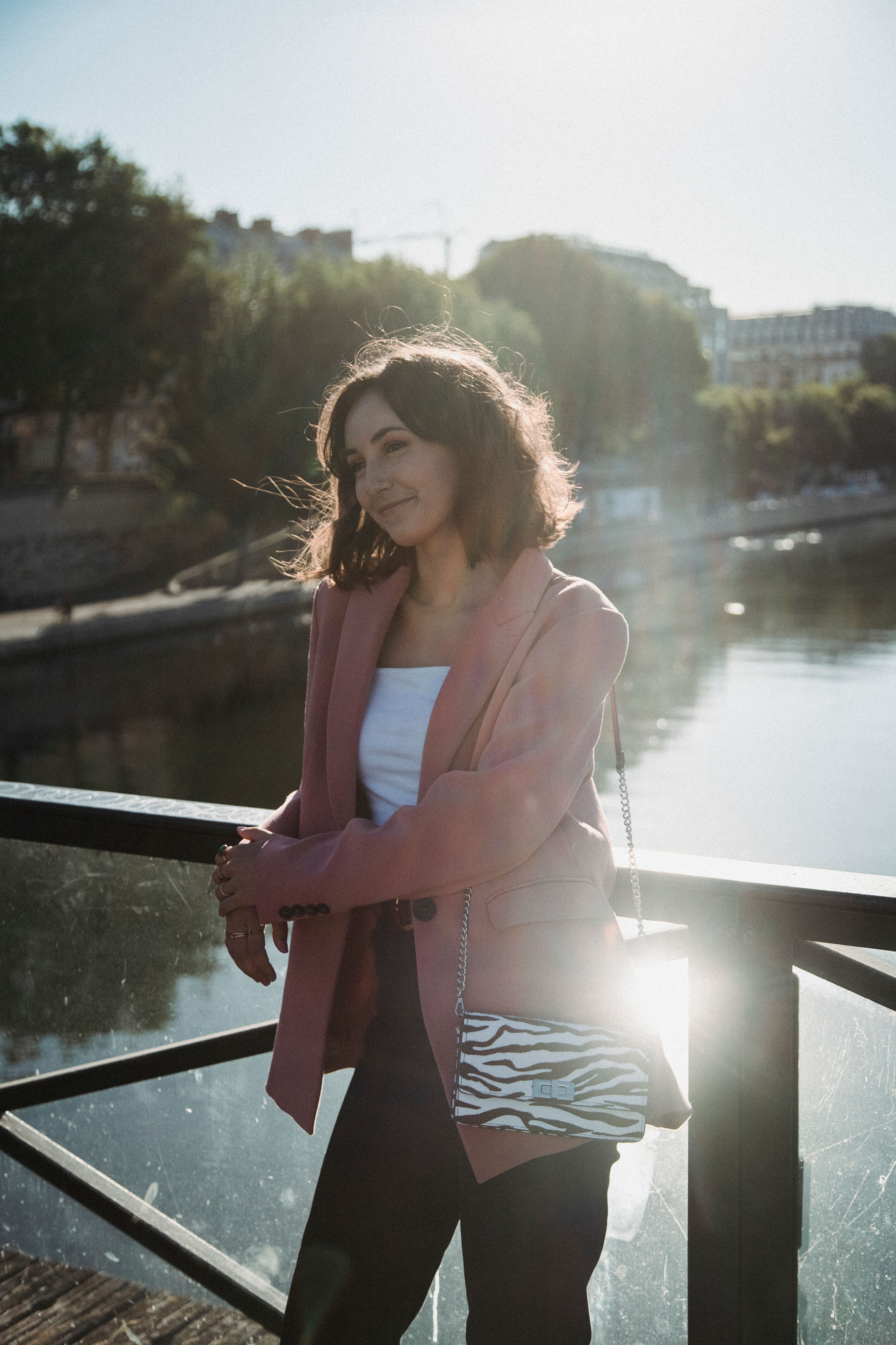 Woman in Pink Blazer Leaning on a Railing · Free Stock Photo