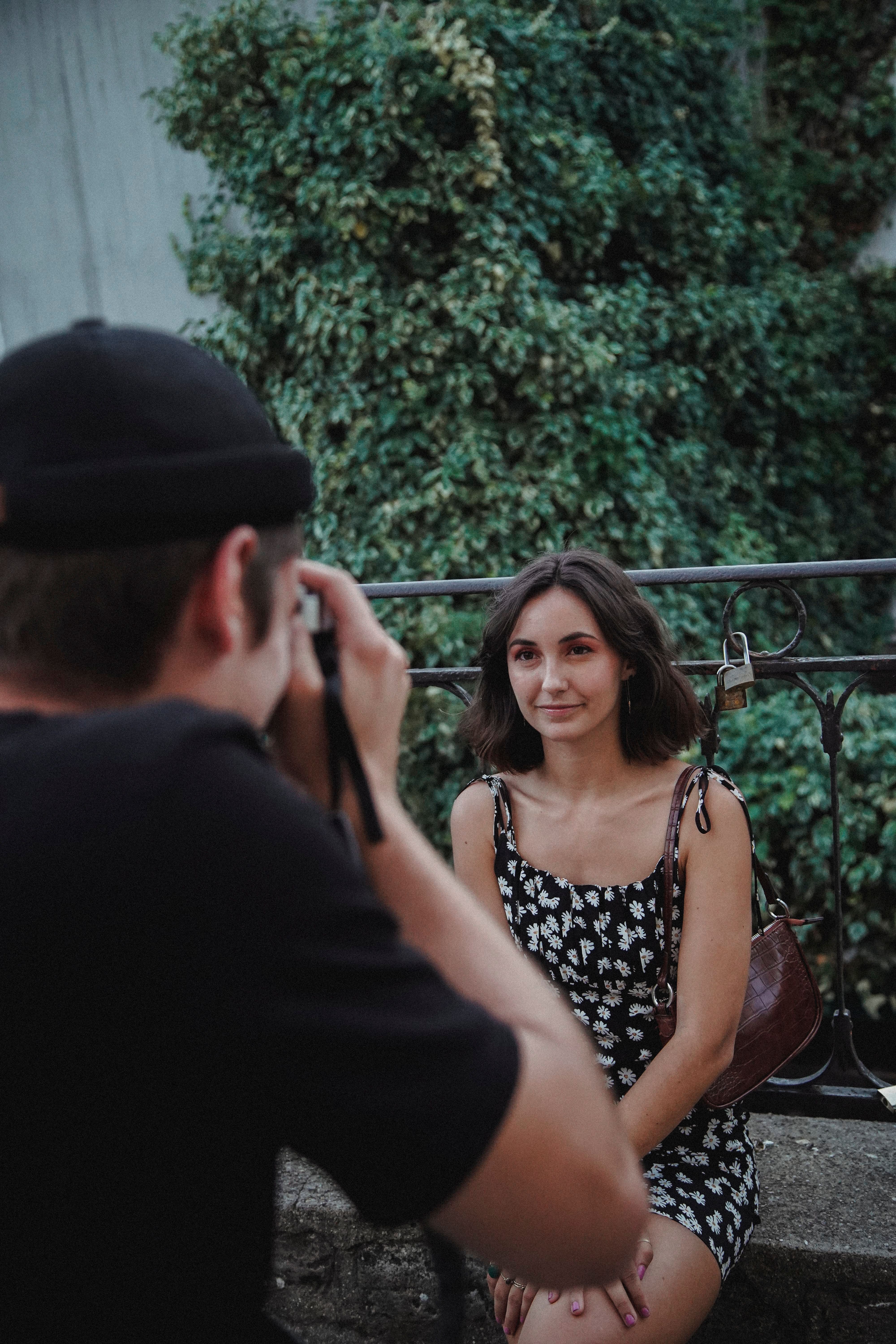 Woman in Black and White Floral Dress Smiling for a Photo · Free Stock ...