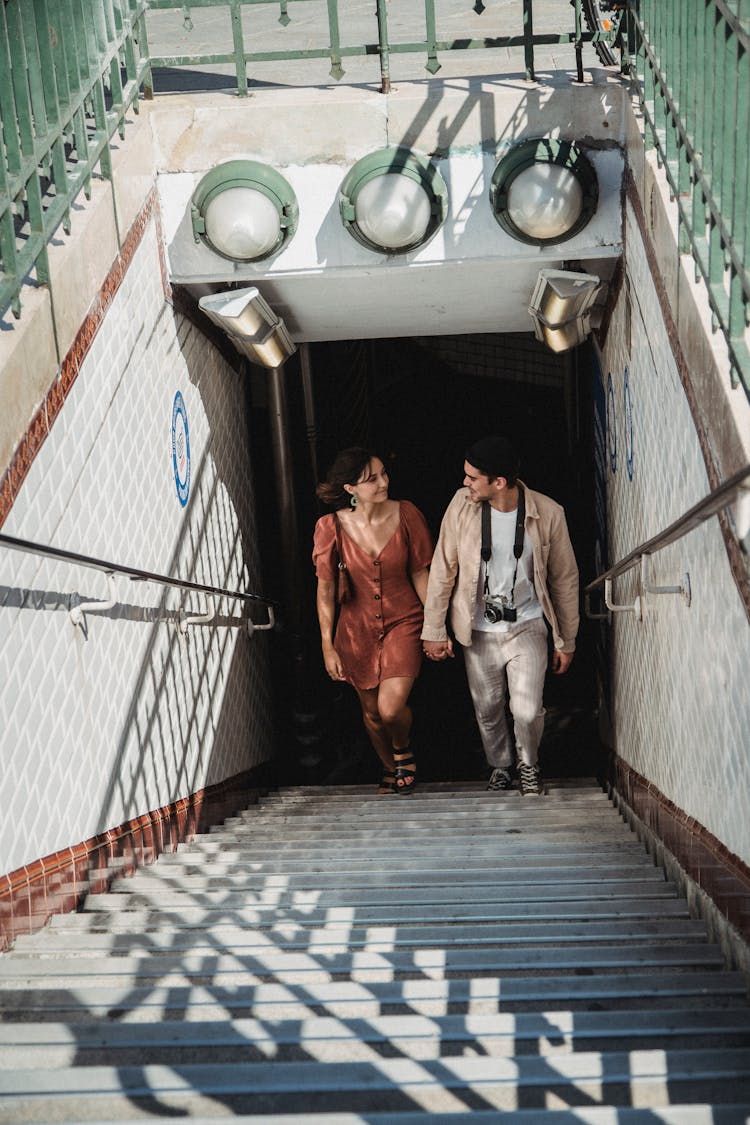 Man And Woman Going Up The Stairs