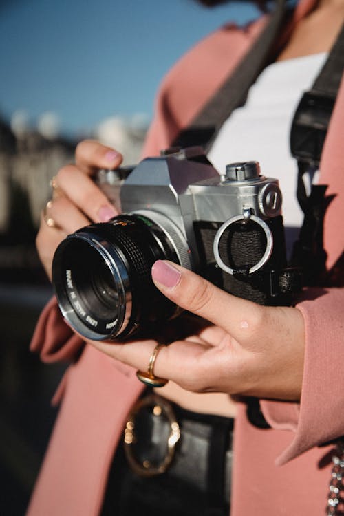 Person Holding Black and Silver Camera