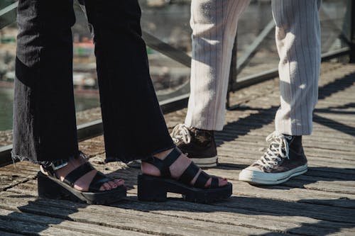 People Wearing Sneakers and Sandals
