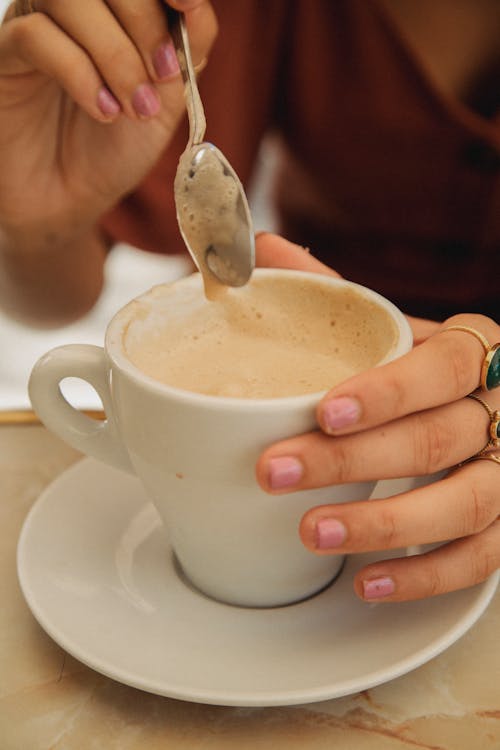 Person Holding White Ceramic Cup