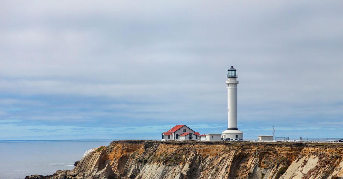 Beautiful coastal view of Point Arena Lighthouse perched on a dramatic cliff in California.