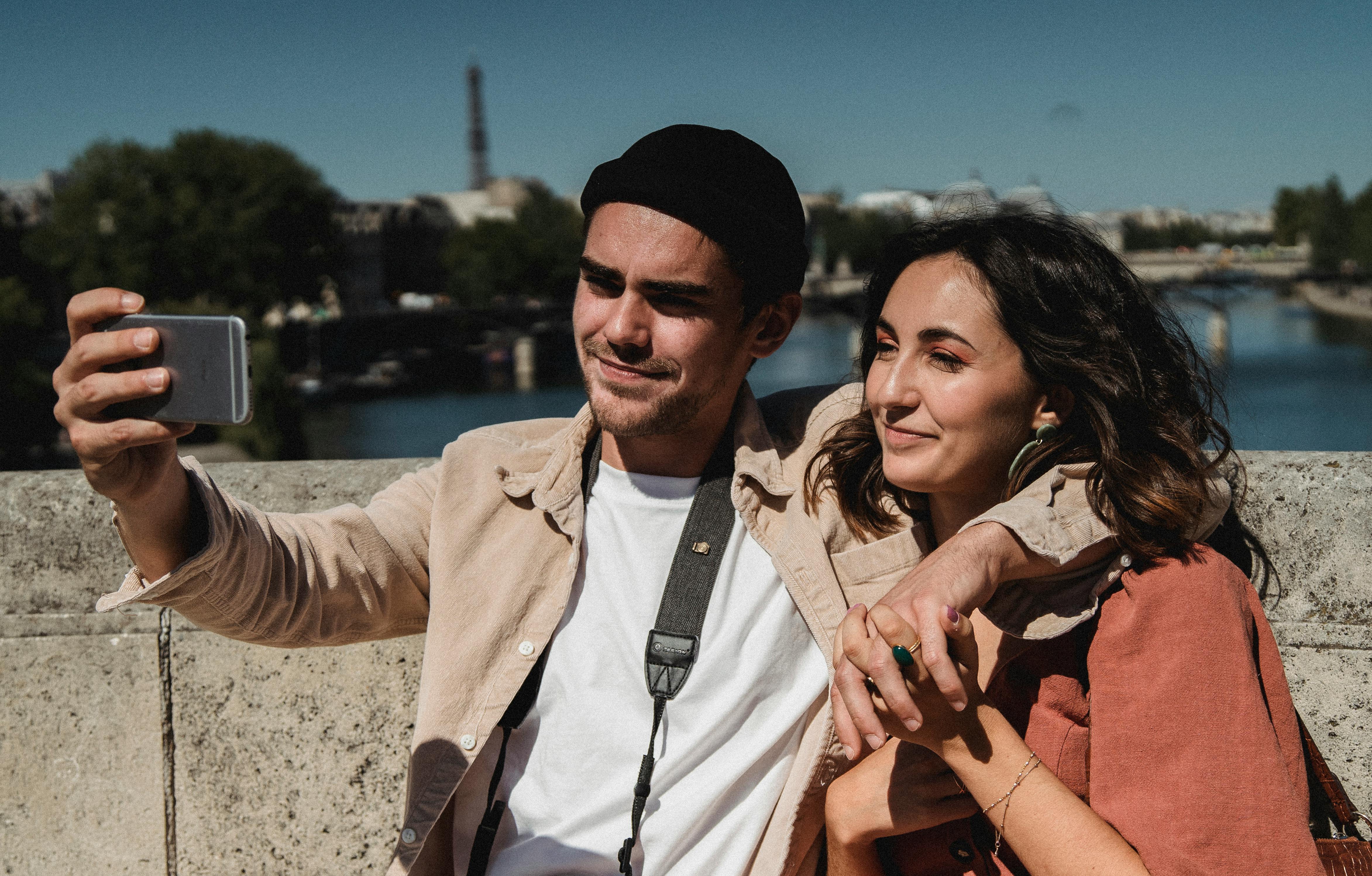 anxious traveler showing their smartphone to an airline agent at the check-in counter