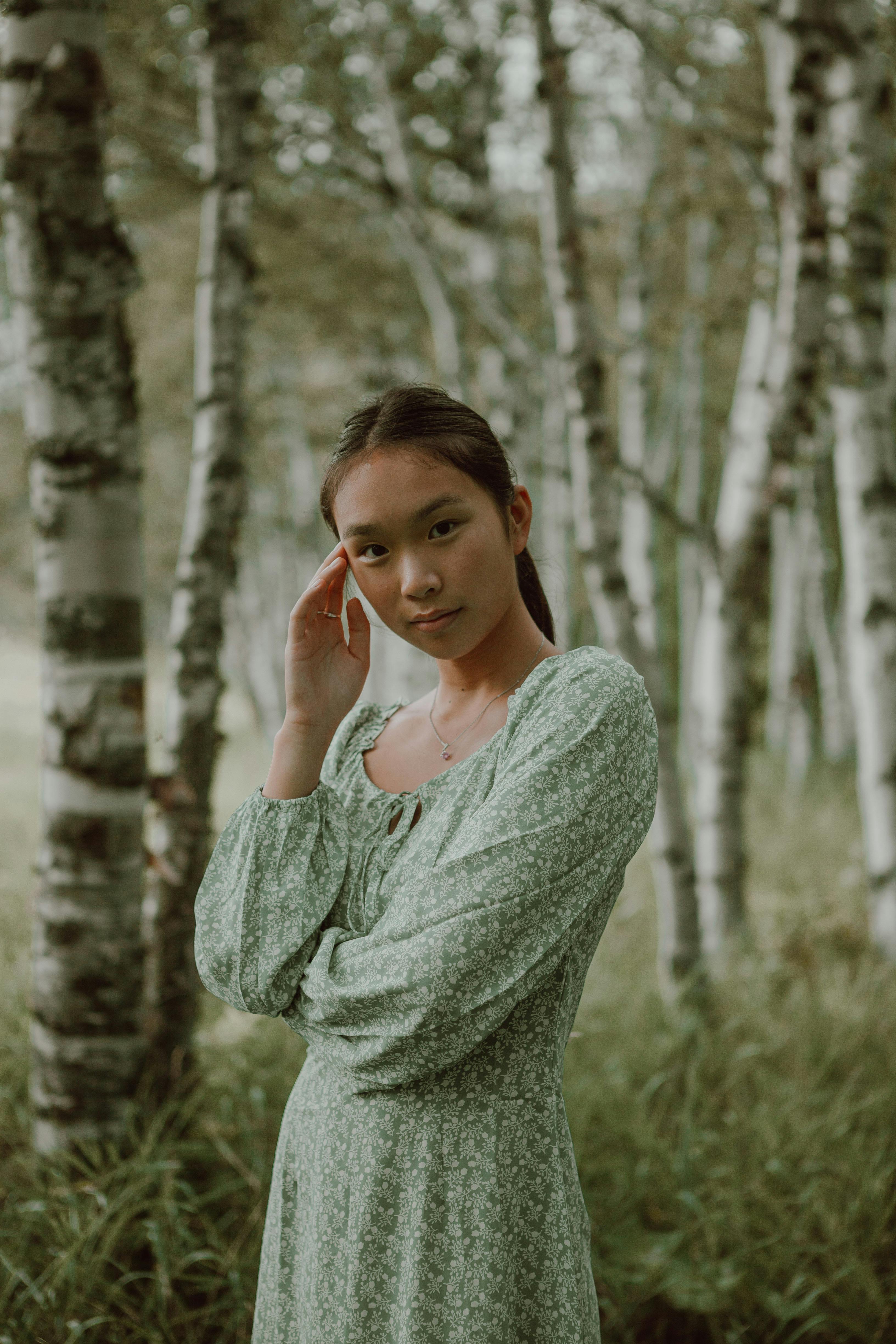 Woman in Green Long Sleeve Shirt Standing Near Trees · Free Stock Photo