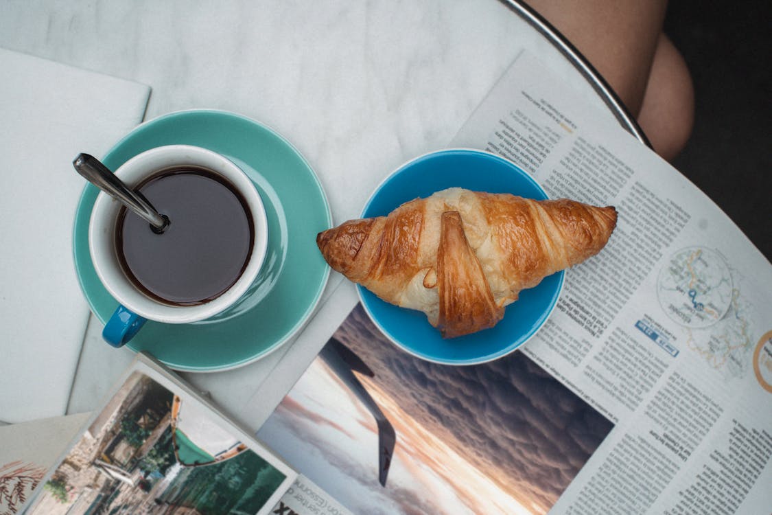 Free Cup of Coffee Beside a Croissant Stock Photo