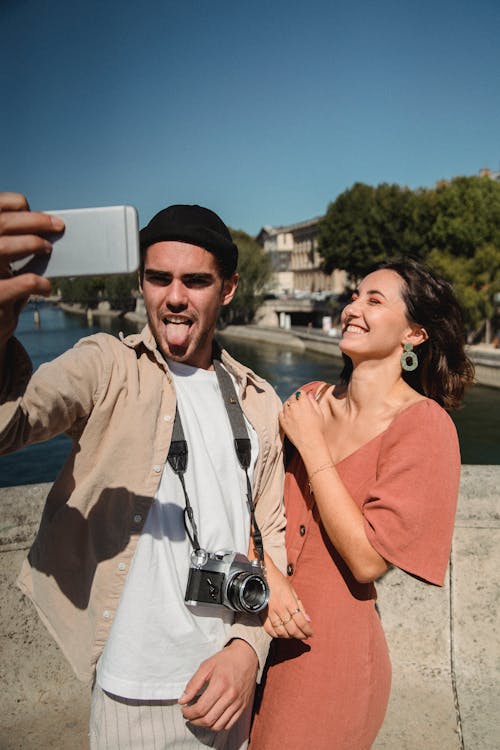 Free Man in Button Up Shirt Holding a Smartphone Stock Photo