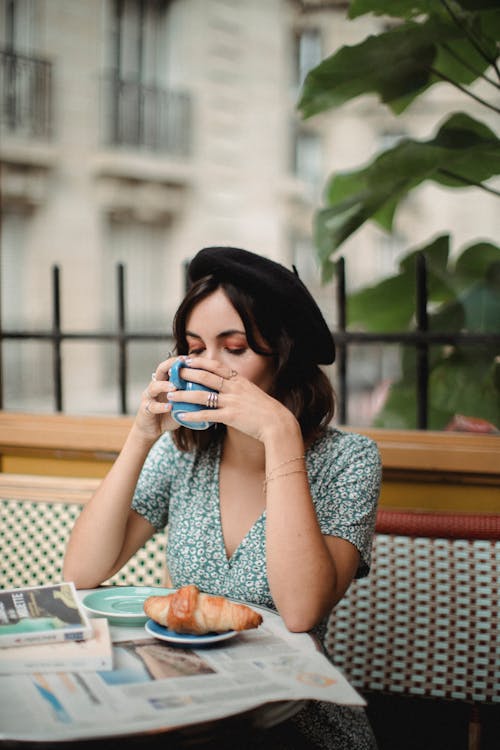 Free Woman in Blue and White Floral Dress Drinking Stock Photo