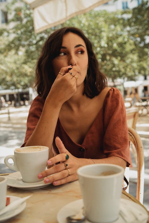 Free Woman in Brown Dress Holding a Cup Stock Photo