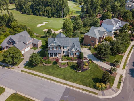 Aerial shot showcasing suburban homes and lush greenery in Raleigh, NC.