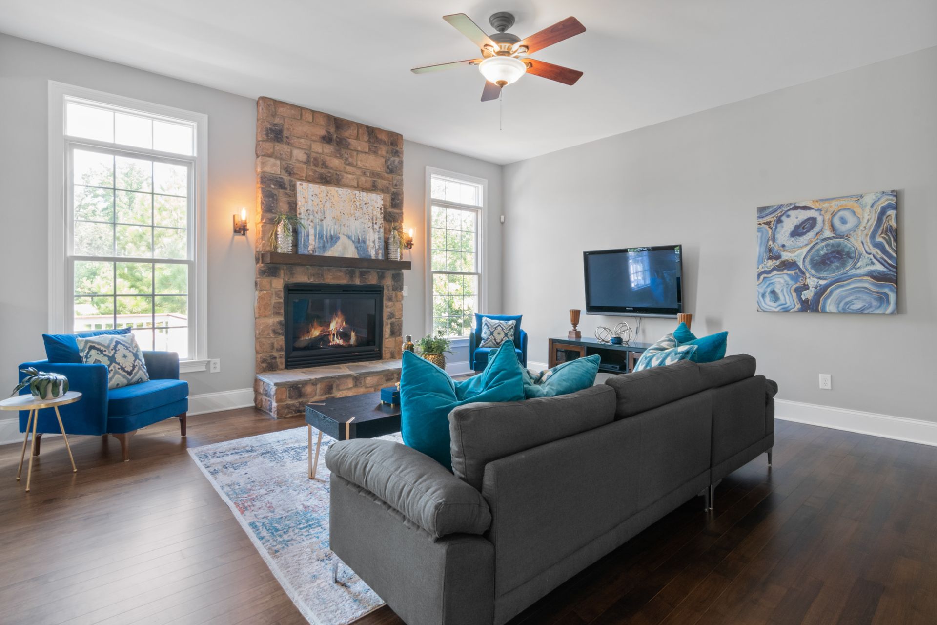 Bright, modern living room featuring a cozy fireplace and stylish decor.