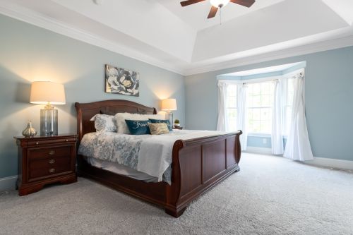 Free Spacious and elegant bedroom featuring classic wooden furniture and soft lighting. Stock Photo