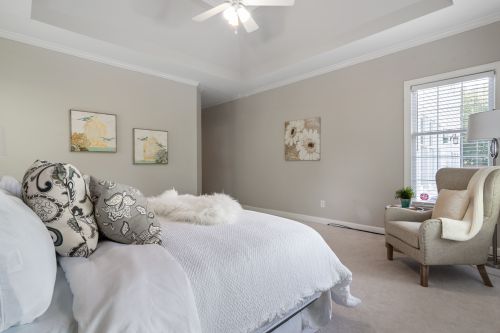 Free Bright, modern bedroom interior with bed, armchair, and stylish decor. Stock Photo