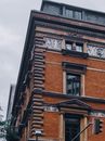 From below of old building with classic exterior of walls and windows on city street