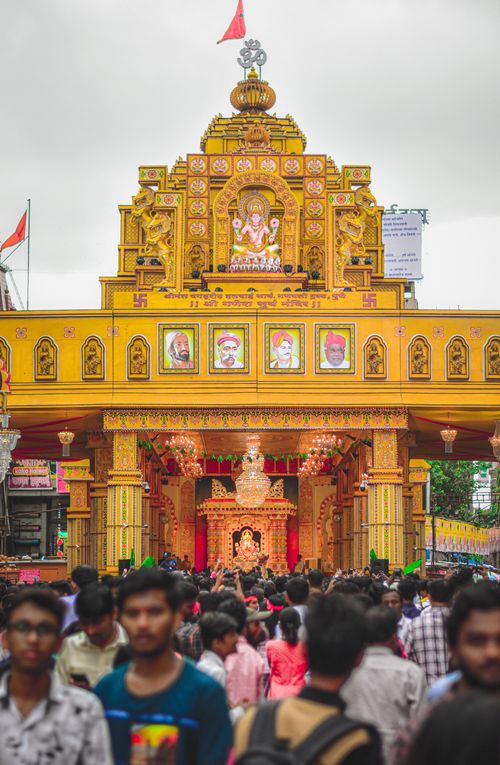 Free Crowds gather at a decorated temple in Pune for Ganesh Chaturthi festival, showcasing vibrant Indian culture. Stock Photo