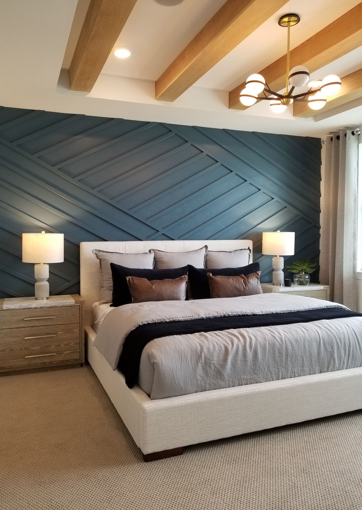 Moody modern bedroom with deep navy accent wall