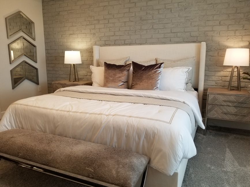 Staged primary bedroom with symmetrical nightstands in a Lake Nona home Staged primary bedroom with symmetrical nightstands in a Lake Nona home