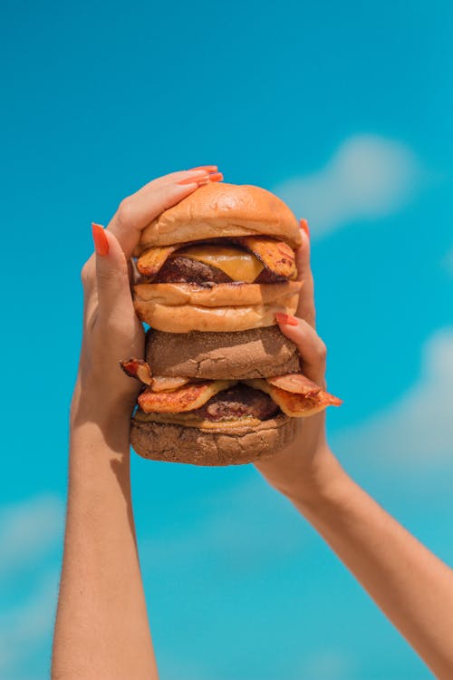 Free Person Holding Burgers with Bacon Stock Photo